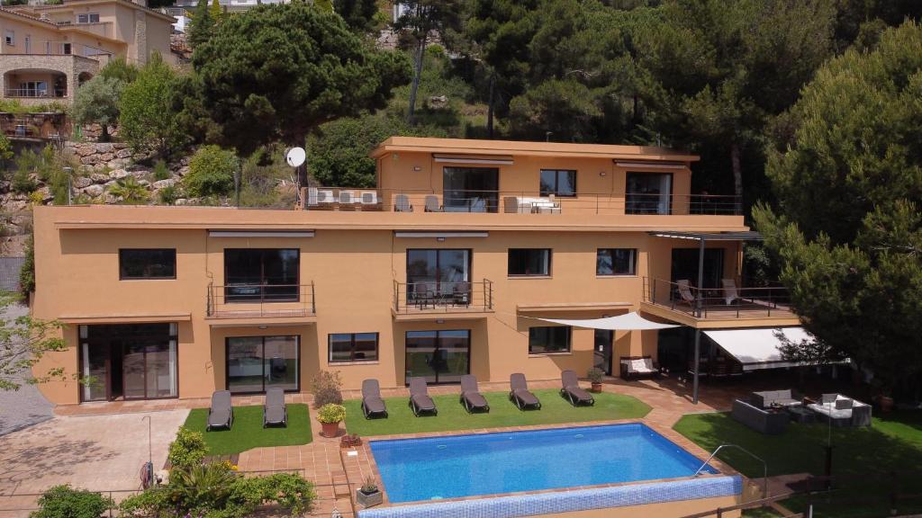 an aerial view of a house with a swimming pool at VILLA LA CALA with swimming pool & sea view, 10 min walk from the sea in Blanes