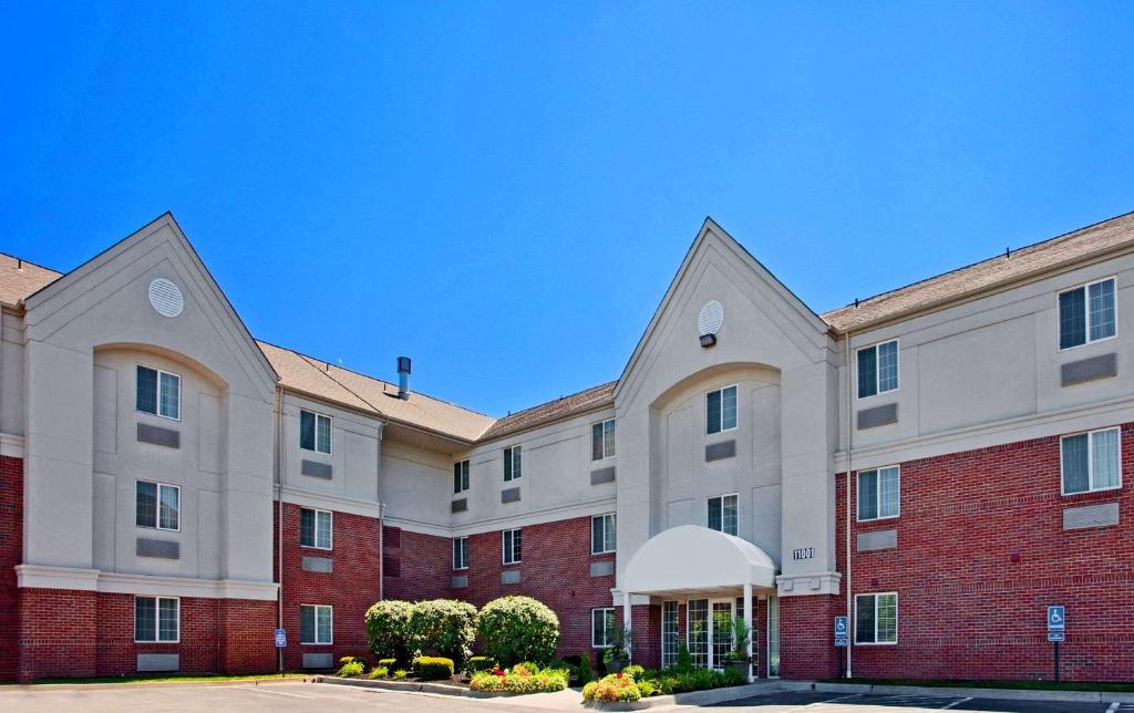 a large building with a red and white at MainStay Suites- Kansas City Overland Park in Overland Park
