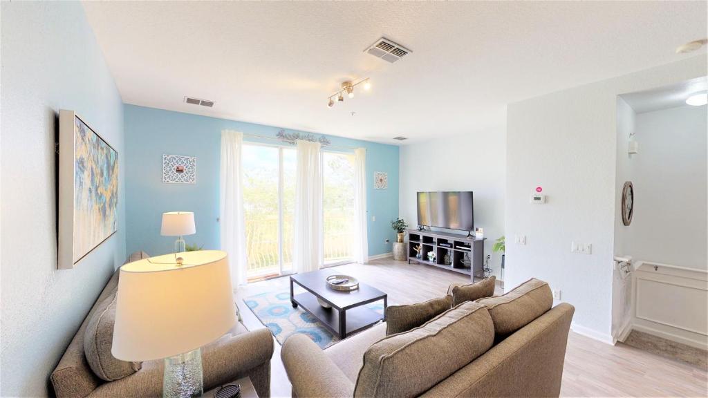 a living room with two couches and a tv at Lovely Townhome at Vista Cay Resort near WDW in Orlando