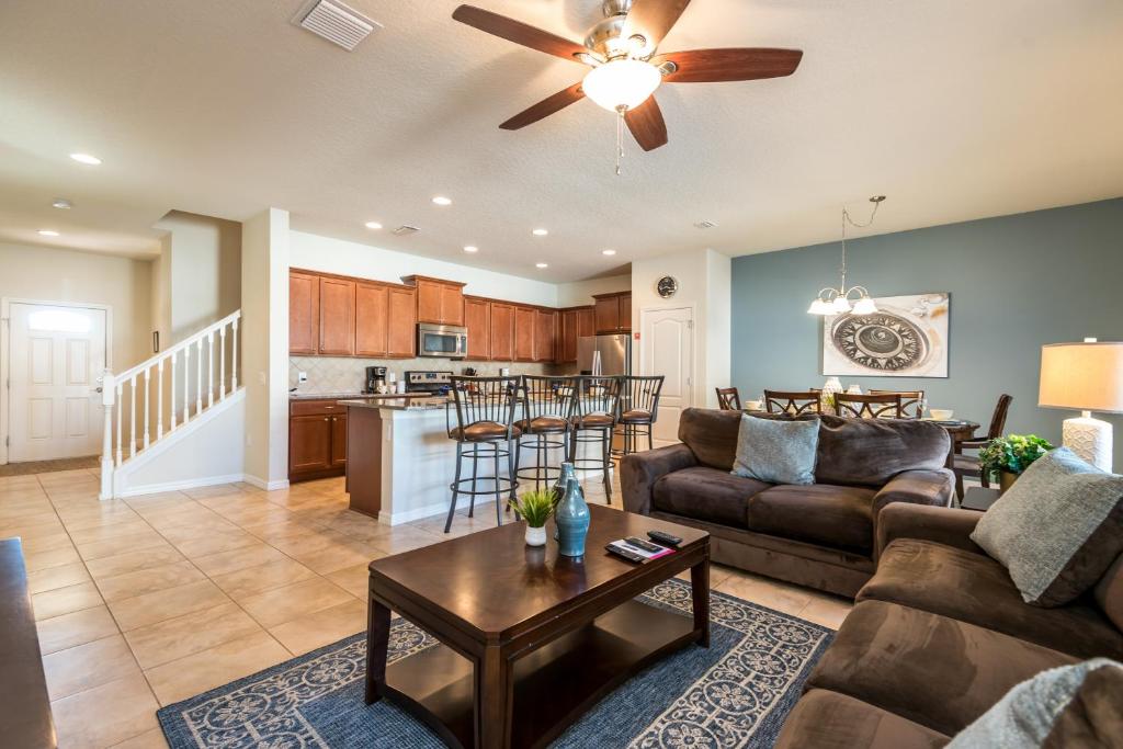 a living room with a couch and a table at Townhome wPrivate Pool & FREE on-site Water Park in Kissimmee