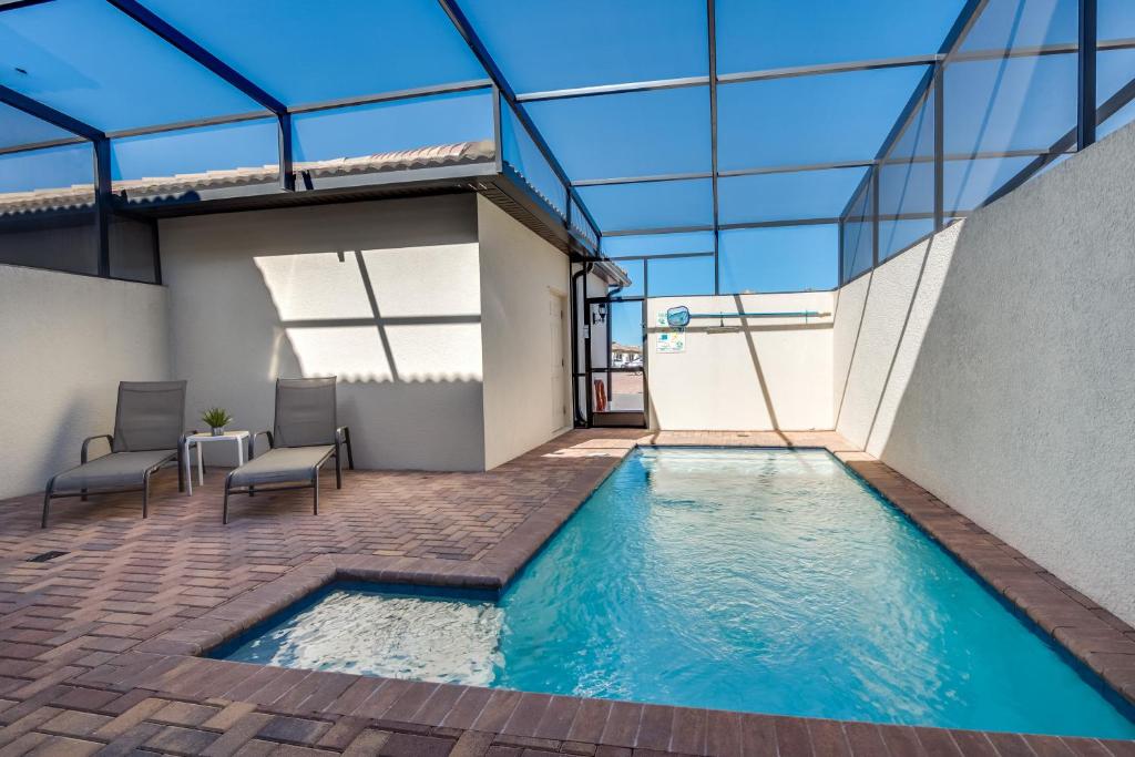 a swimming pool in a building with a glass ceiling at Townhome wPrivate Pool & FREE on-site Water Park in Kissimmee
