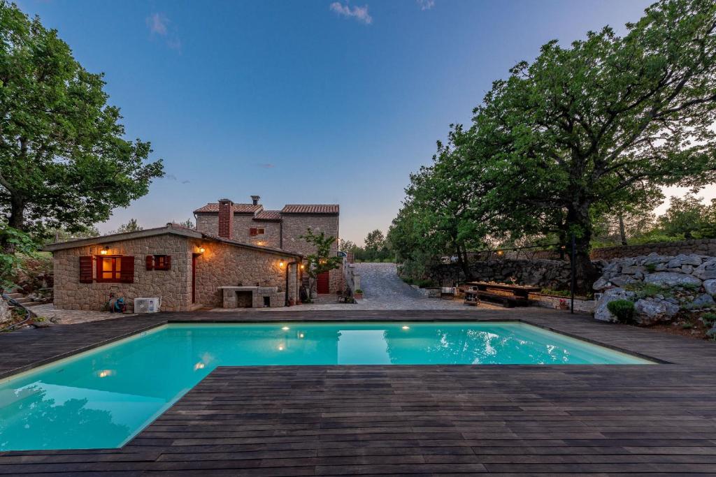 a swimming pool in the backyard of a house at Villa Stone House Magarac in Seline