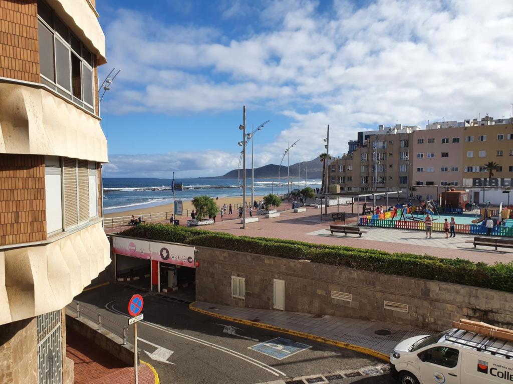 a view of the beach from a building with a parking lot at Ocean Rest Canteras Beach & Parking in Las Palmas de Gran Canaria