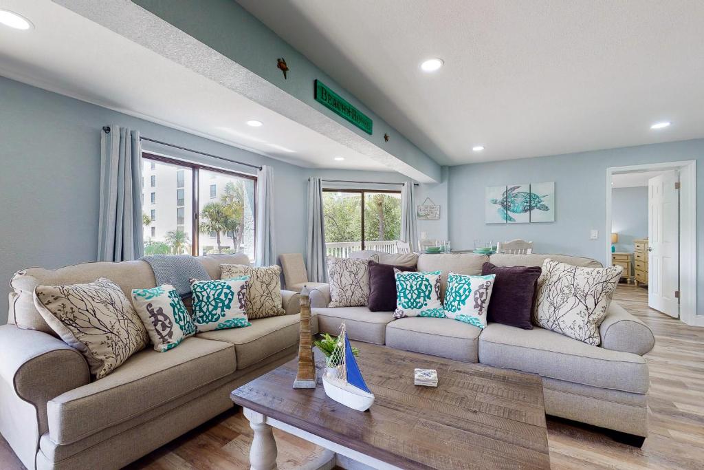 a living room with a couch and a table at Water View 107 in Clearwater Beach