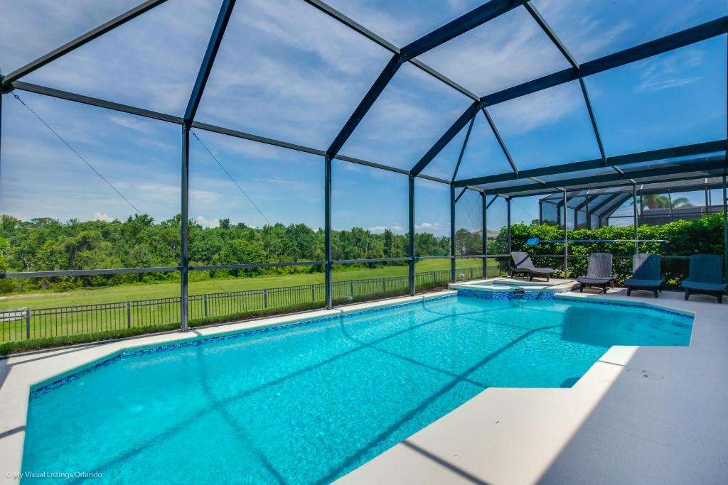 an overhead view of a swimming pool with a glass roof at Private Pool Spa No Rear Neighbors Game Room in Kissimmee
