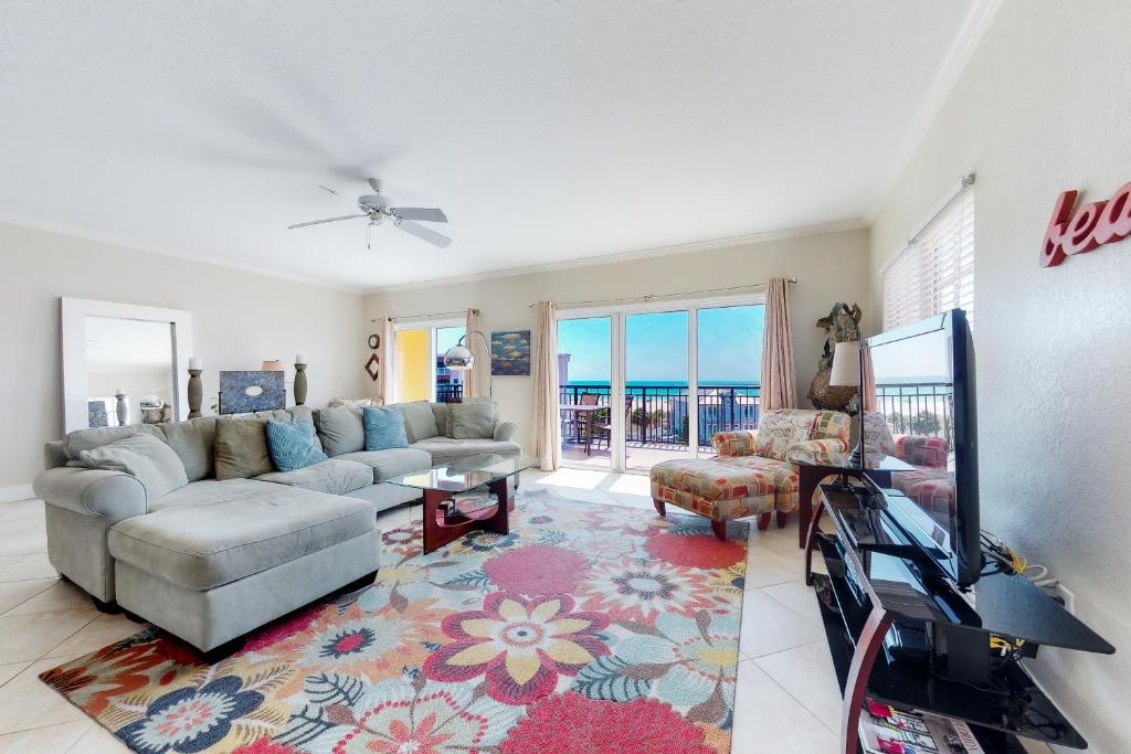 a living room with a couch and a tv at Palms of Treasure Island 405 in St Pete Beach
