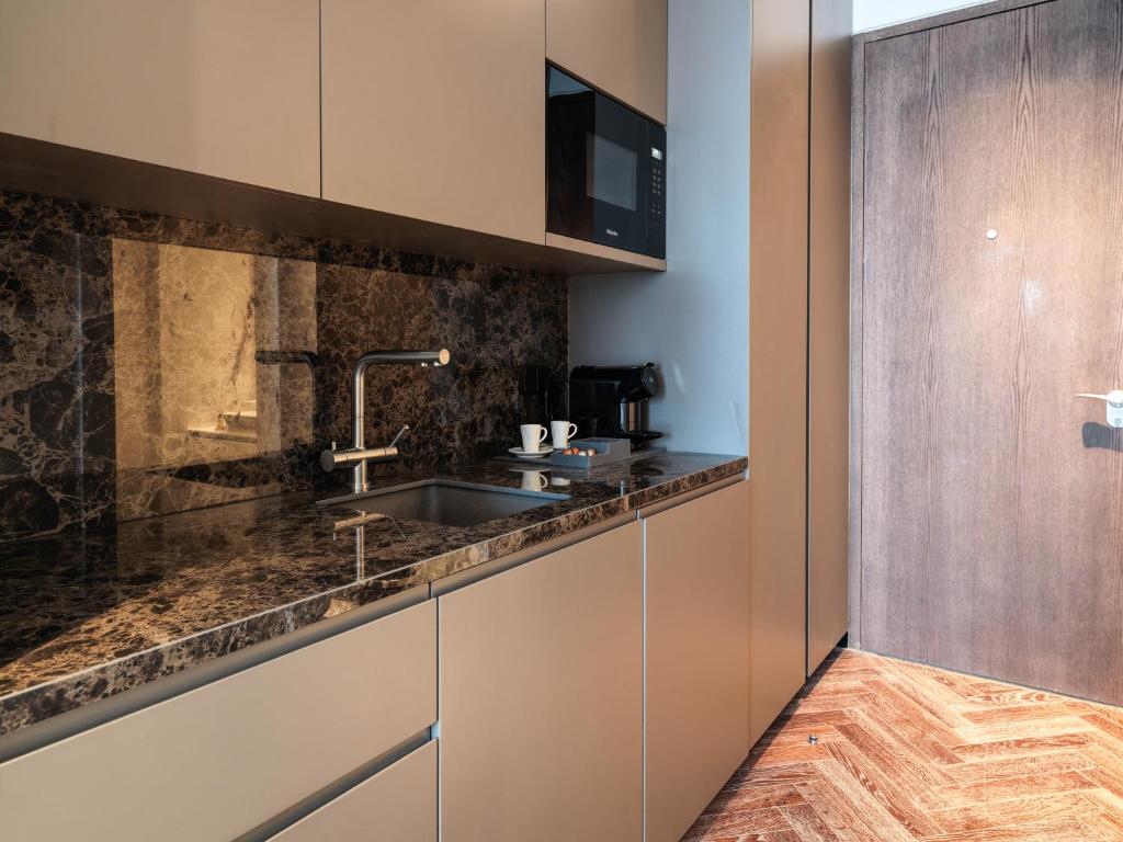 a kitchen with a sink and a counter at Limassol Del Mar in Limassol