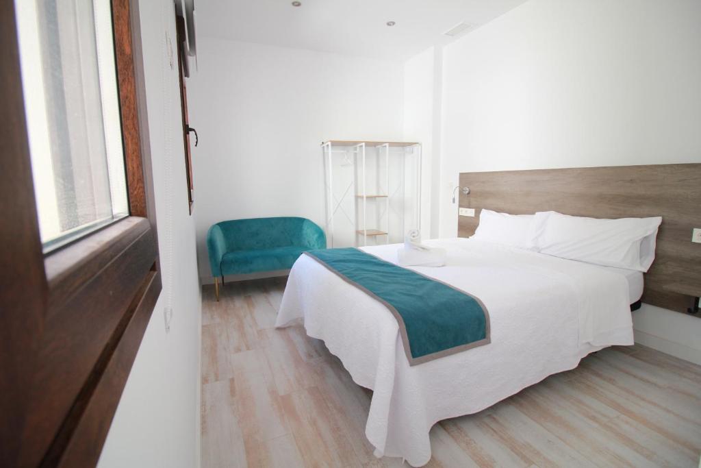 Postel nebo postele na pokoji v ubytování GLORIA SUITES