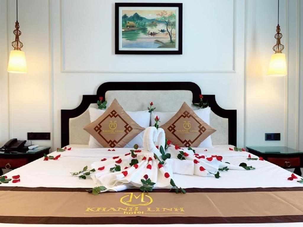 um quarto com uma cama grande com flores em Khanh Linh Hotel em Da Nang