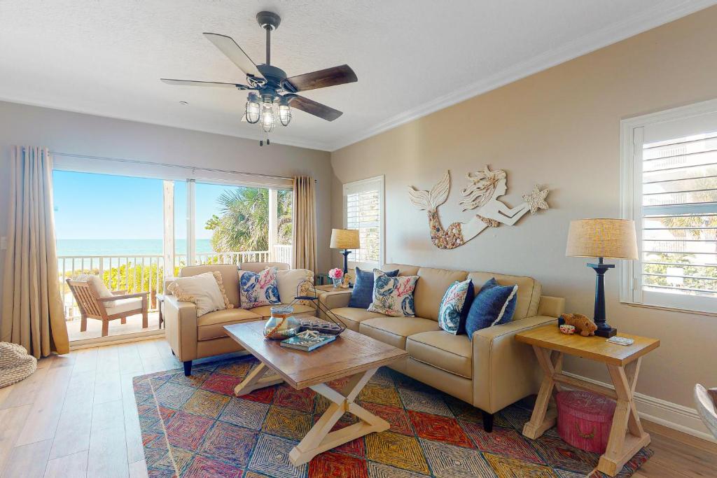 uma sala de estar com um sofá e uma mesa em On The Rocks 1 em Clearwater Beach
