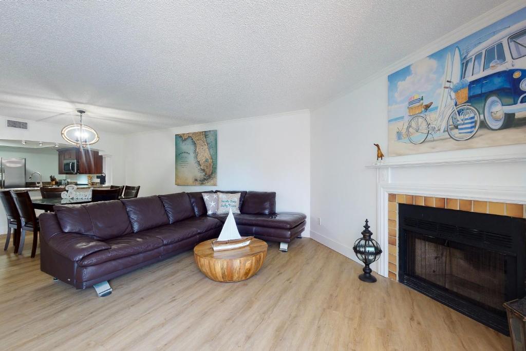a living room with a couch and a fireplace at Beach Cottage 1104 in Clearwater Beach