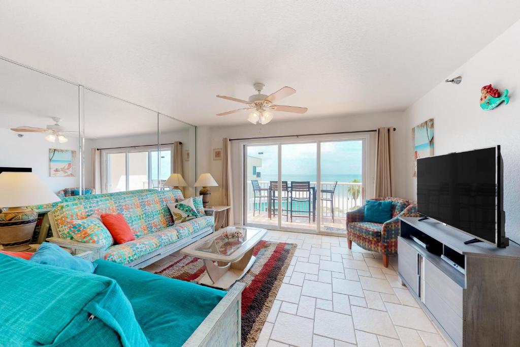 a living room with a couch and a flat screen tv at Indian Sunset Beach 7 in Clearwater Beach