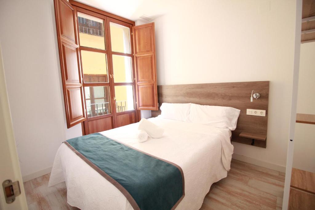 Postel nebo postele na pokoji v ubytování GLORIA SUITES