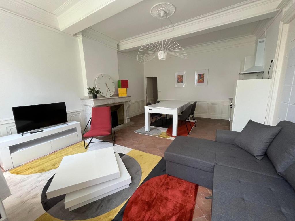 ein Wohnzimmer mit einem Sofa und einem Tisch in der Unterkunft Convivial PAUL SIBRA-T2-BILLARD- wifi-Vélo in Castelnaudary
