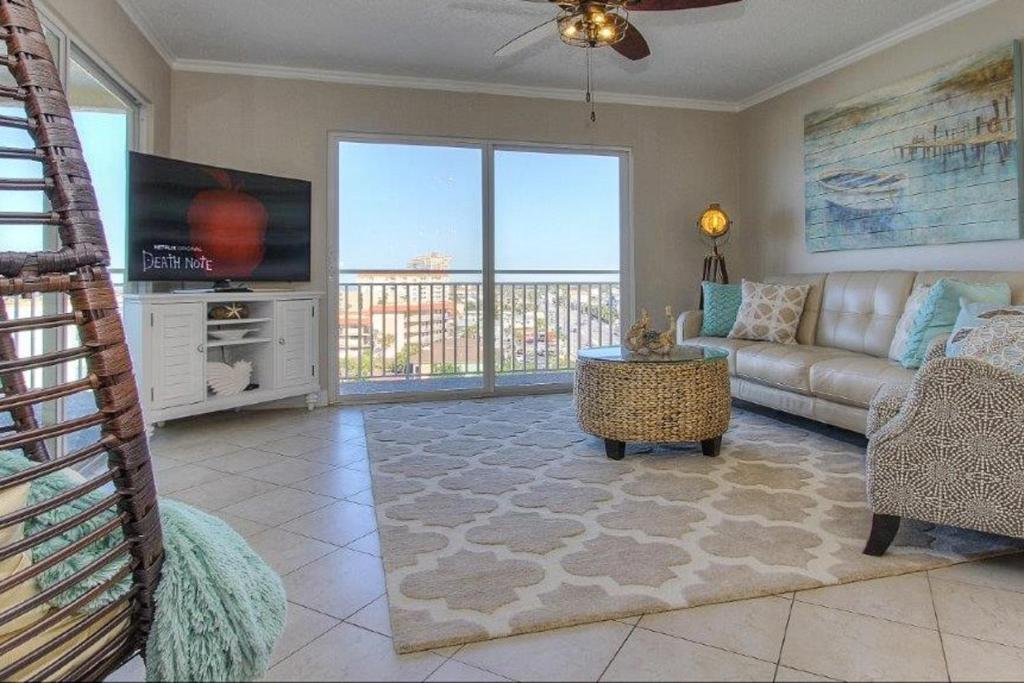 a living room with a couch and a tv at Anglers Cove 608 in St Pete Beach