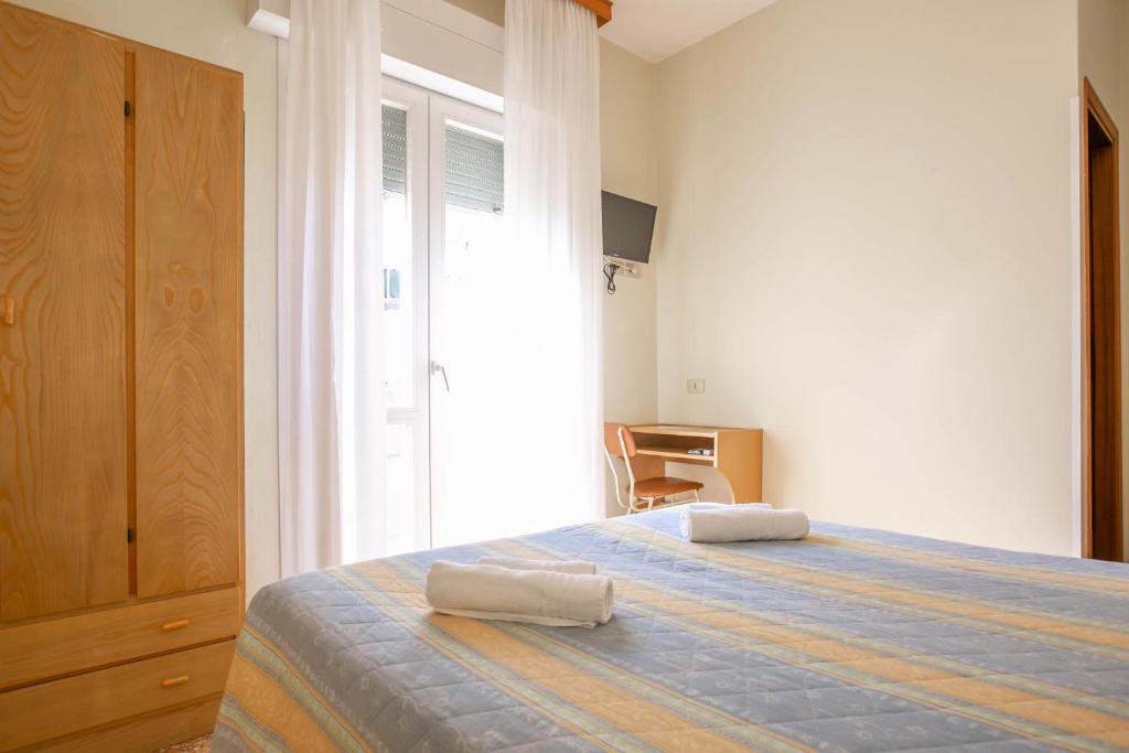Postel nebo postele na pokoji v ubytování Hotel Ischia