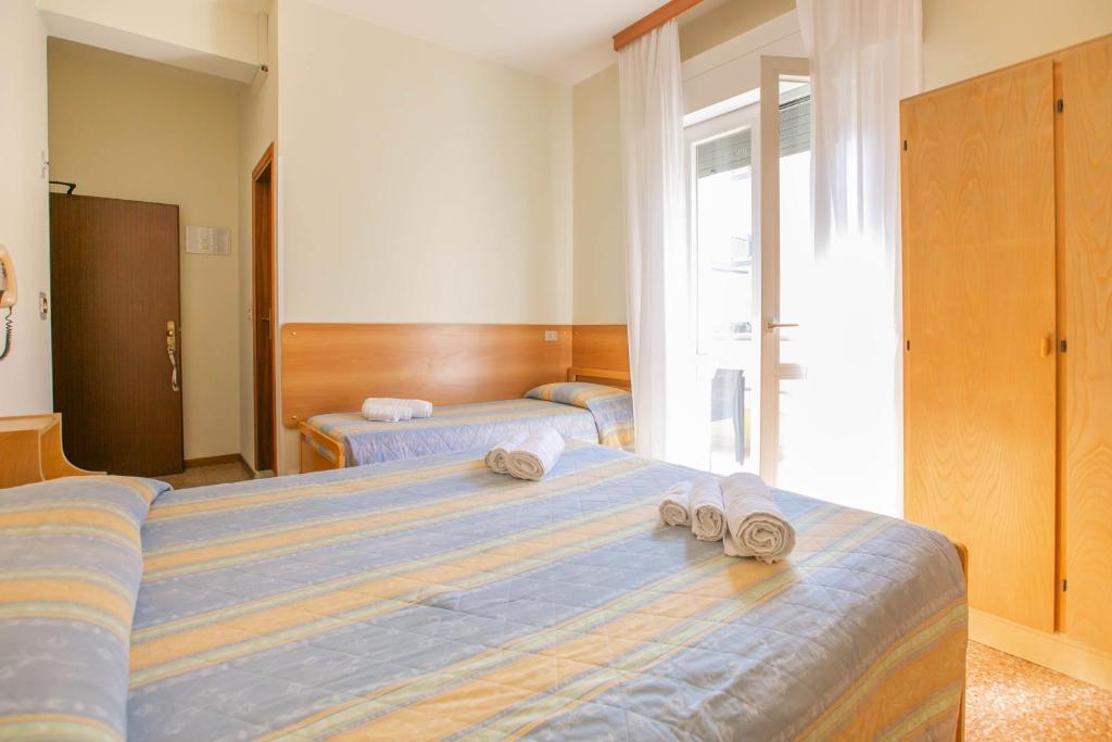 Postel nebo postele na pokoji v ubytování Hotel Ischia