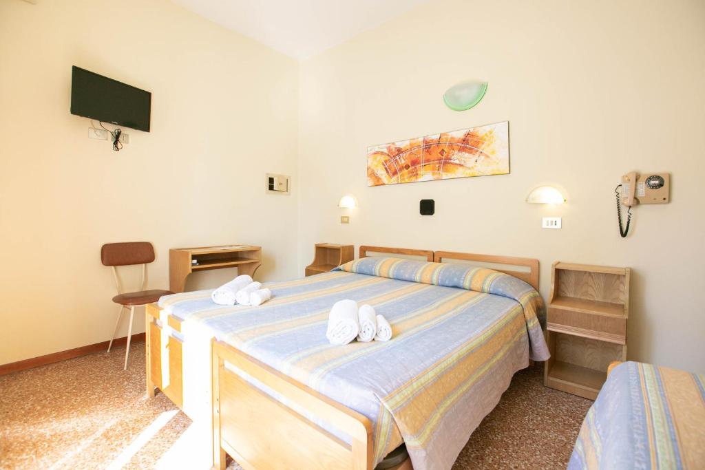 Postel nebo postele na pokoji v ubytování Hotel Ischia