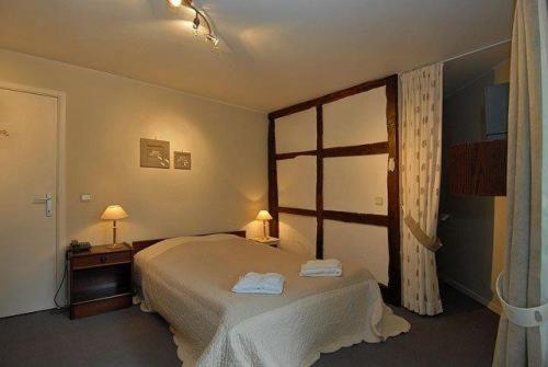 Postel nebo postele na pokoji v ubytování Hostellerie Au Vieux Hetre