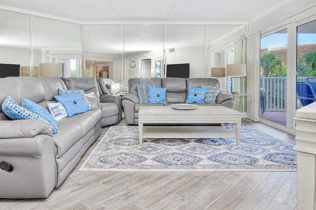 a living room with a couch and a table at Beach Cottage 1205 in Clearwater Beach