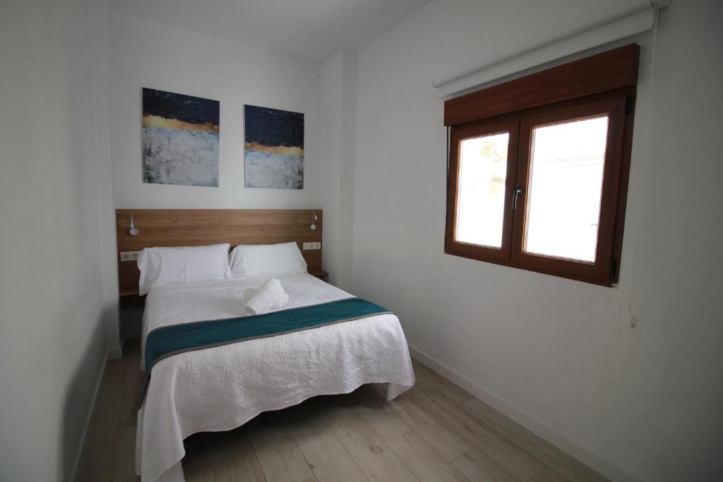 Postel nebo postele na pokoji v ubytování GLORIA SUITES