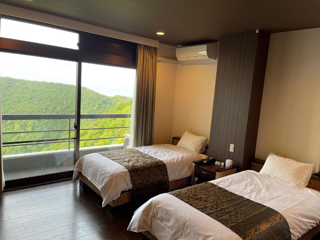 Postel nebo postele na pokoji v ubytování Hotel Bokaiso