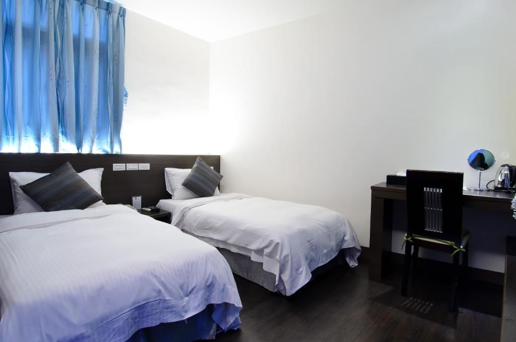 Postel nebo postele na pokoji v ubytování Yuh-Tarng Hotel