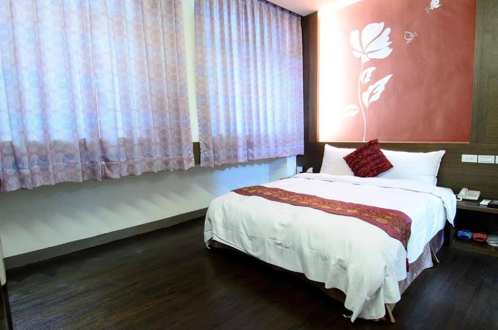 Postel nebo postele na pokoji v ubytování Yuh-Tarng Hotel