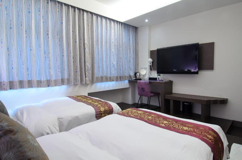 Postel nebo postele na pokoji v ubytování Yuh-Tarng Hotel