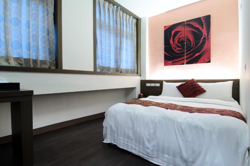 Postel nebo postele na pokoji v ubytování Yuh-Tarng Hotel
