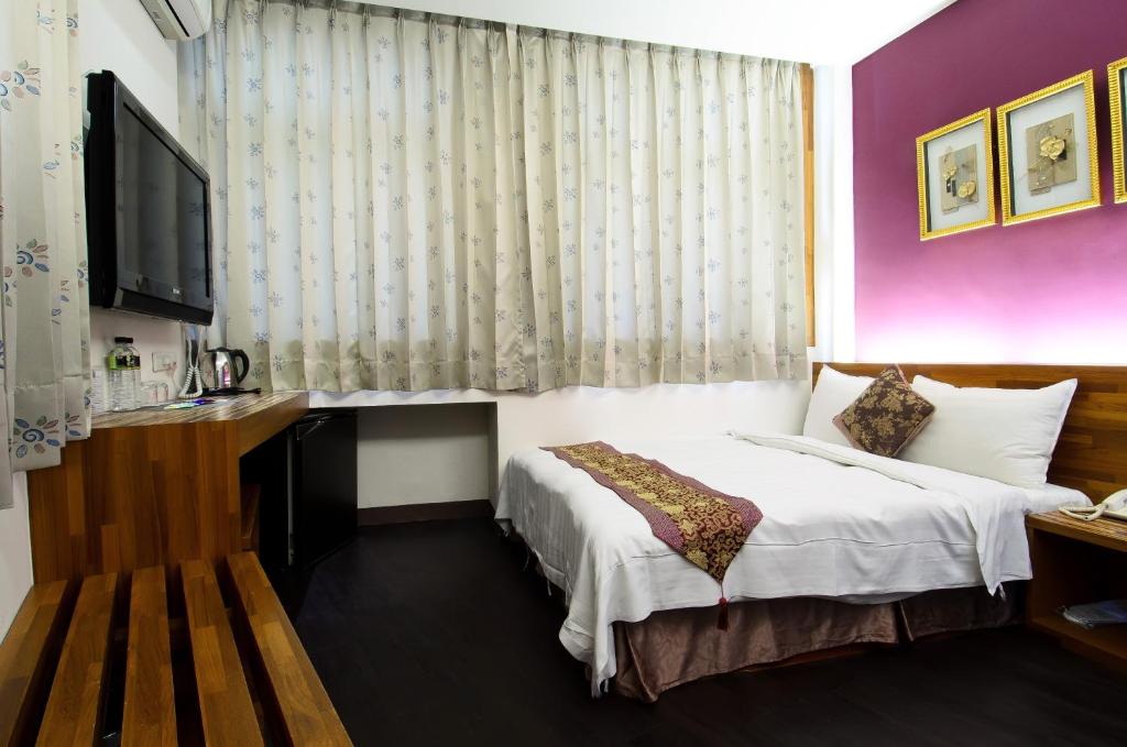 Postel nebo postele na pokoji v ubytování Yuh-Tarng Hotel