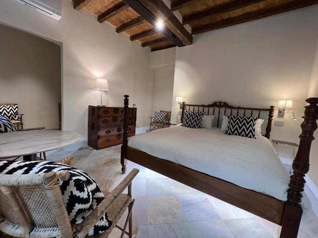 A bed or beds in a room at Palazzo Balbo di Vinadio Apartments