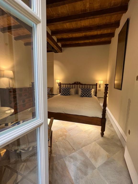 A bed or beds in a room at Palazzo Balbo di Vinadio Apartments