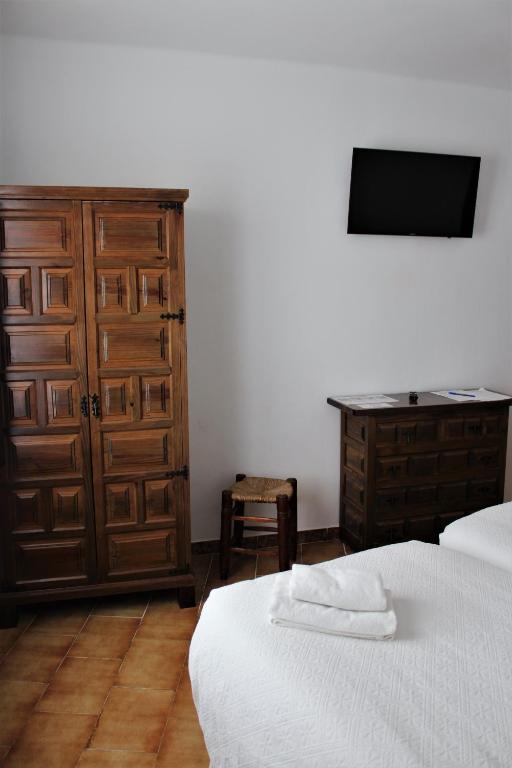 Postel nebo postele na pokoji v ubytování Pensión Sevillano