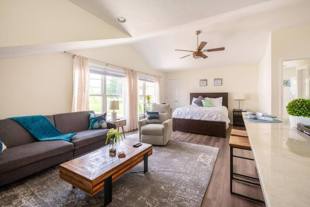 a living room with a couch and a bed at *Cozy Studio Carriage House- Minutes from Downtown in Indianapolis