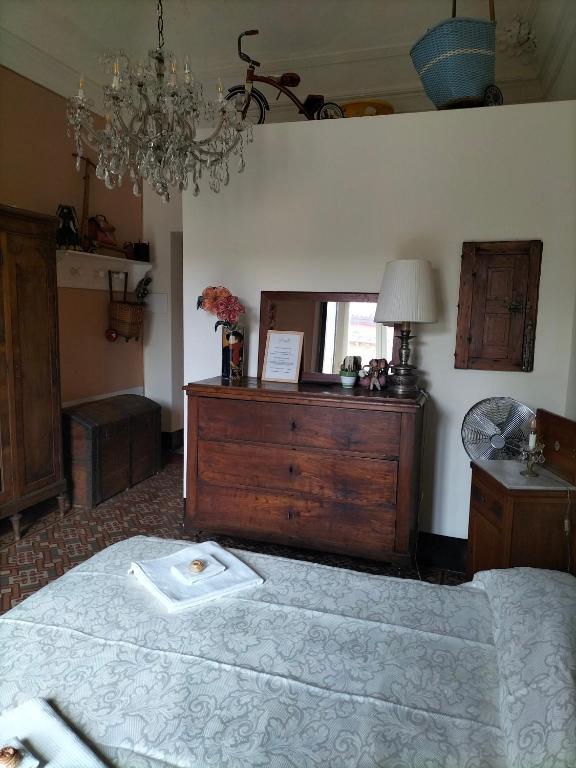a bedroom with a bed with a dresser and a mirror at B&B Chapo in Catania