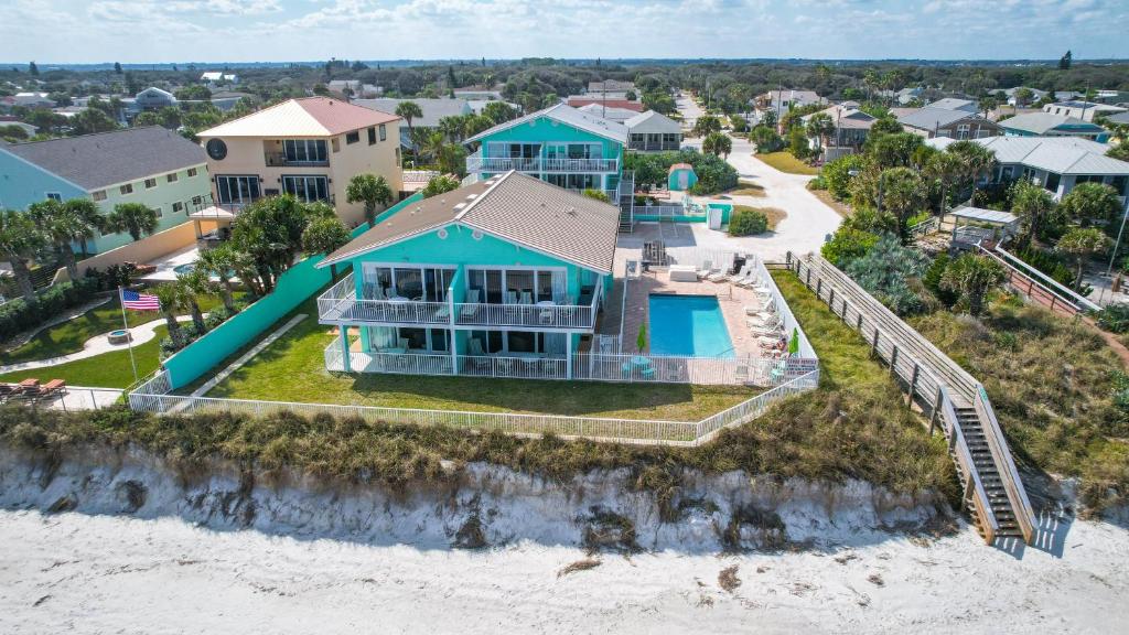 an aerial view of a house on the beach at Ocean Beach Club in New Smyrna Beach