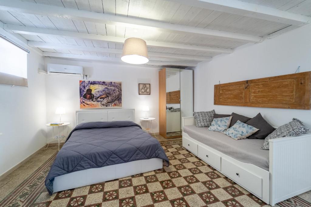 Posteľ alebo postele v izbe v ubytovaní Casa Talete Cozy Apartment in Ortigia - FIRST FLOOR