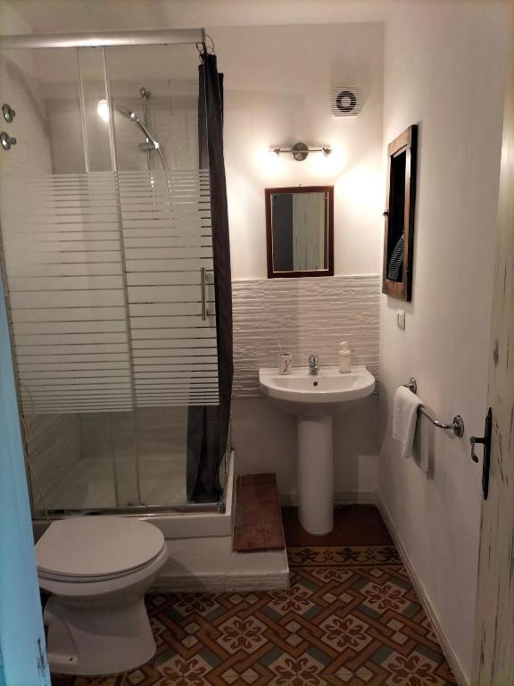 a bathroom with a toilet and a sink and a shower at B&B Chapo in Catania