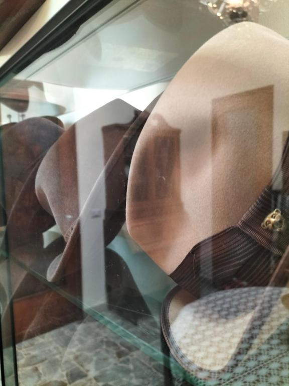 a reflection of a chair in a glass window at B&B Chapo in Catania