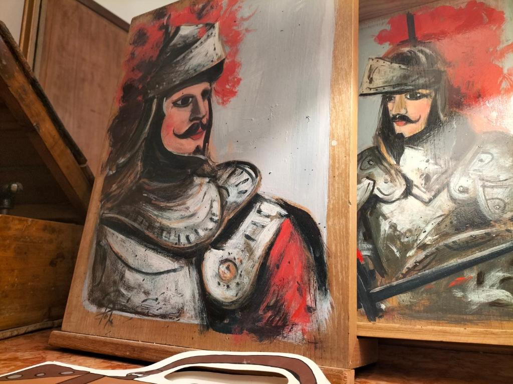 a painting of two women inarmor at B&B Chapo in Catania