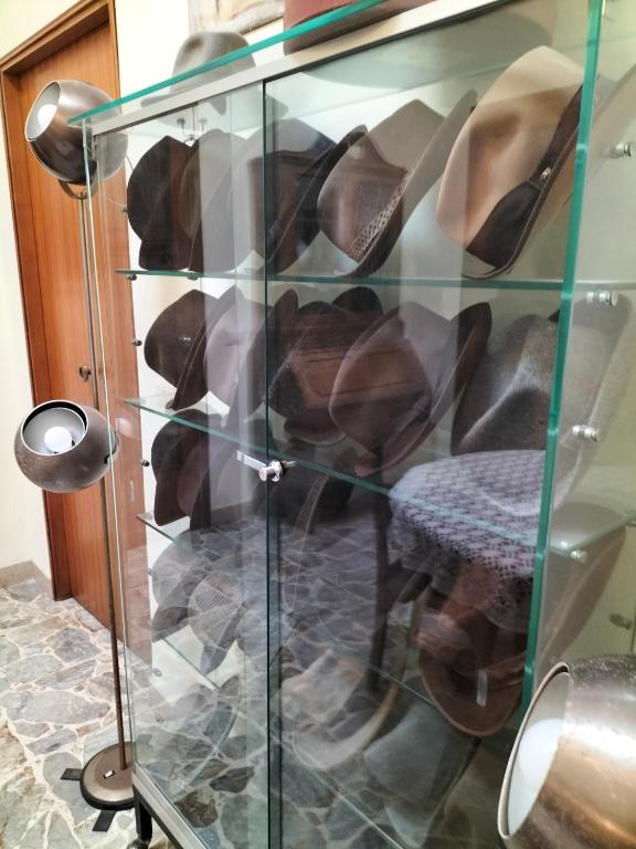 a glass display case with shoes in it at B&B Chapo in Catania