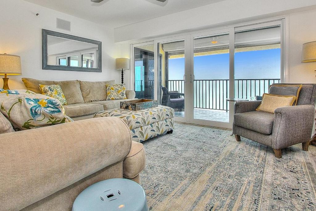 a living room with a couch and a chair at Shore House 502 in Clearwater Beach