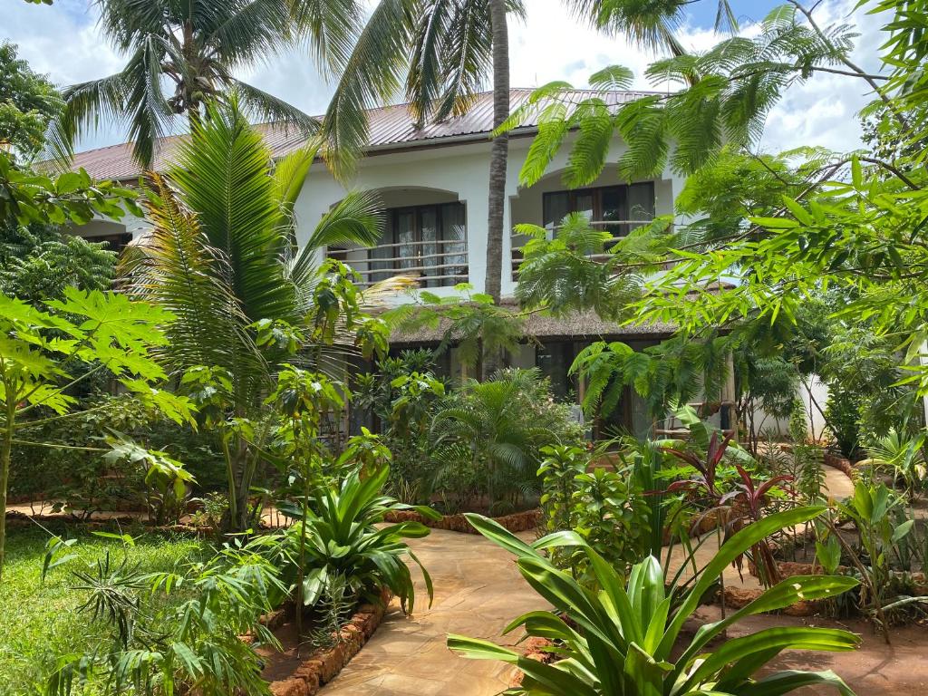 a house in the middle of a jungle with trees at Siri Beach Lodge in Nungwi