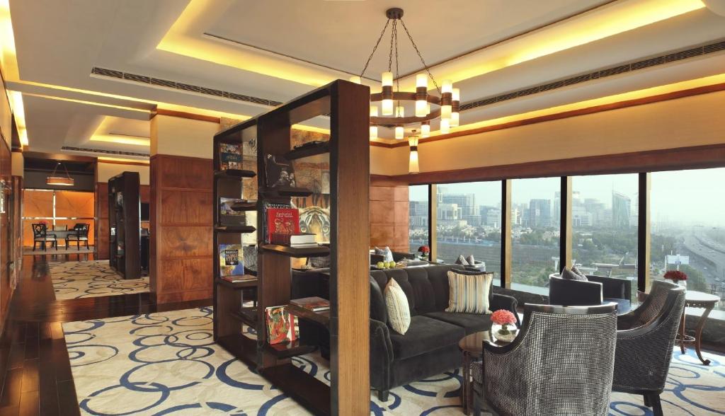 a living room with a couch and a chandelier at The Leela Ambience Gurugram Hotel & Residences - The Luxury Urban Sanctuary in Gurgaon