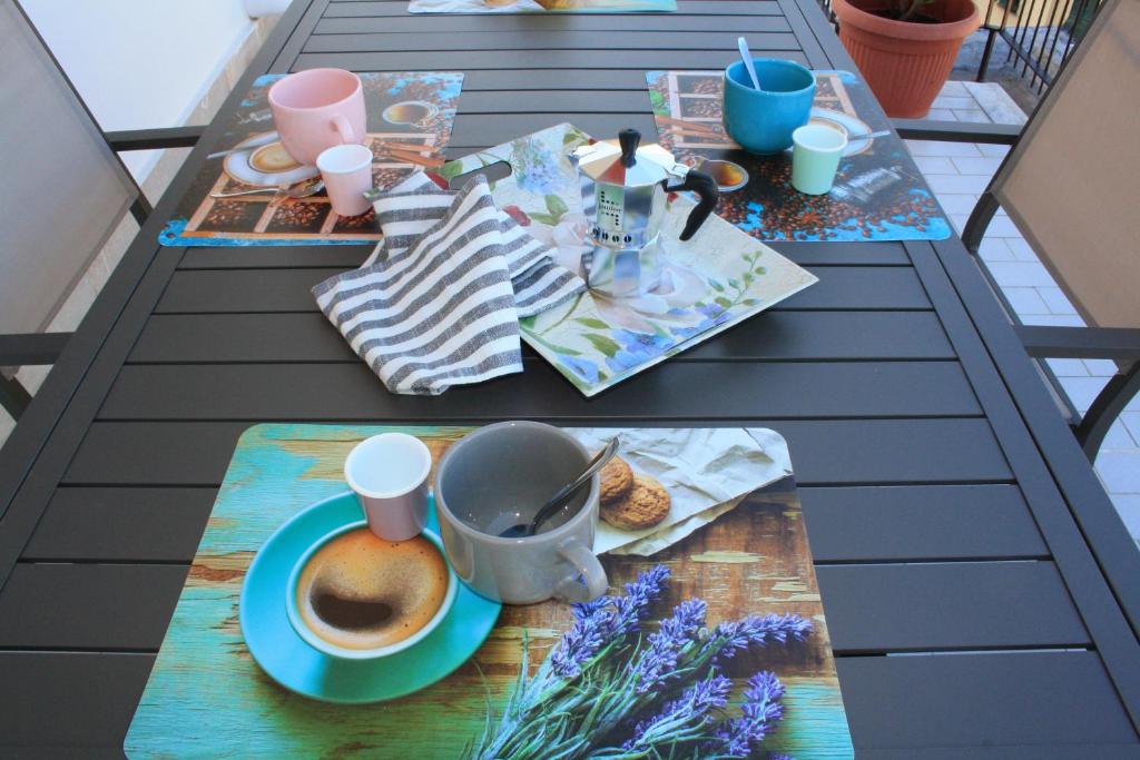 Hotel MICKY HOUSE, a table with a cup of coffee on top of it at MICKY HOUSE in Sanremo