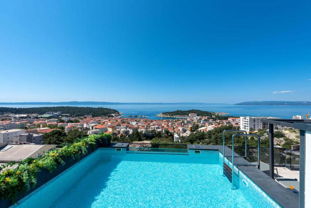 a swimming pool on the roof of a building with a view at Vila Aurelia 2 in Makarska