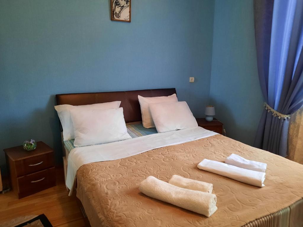 a bedroom with a bed with two towels on it at Sisi Guest House in Kutaisi