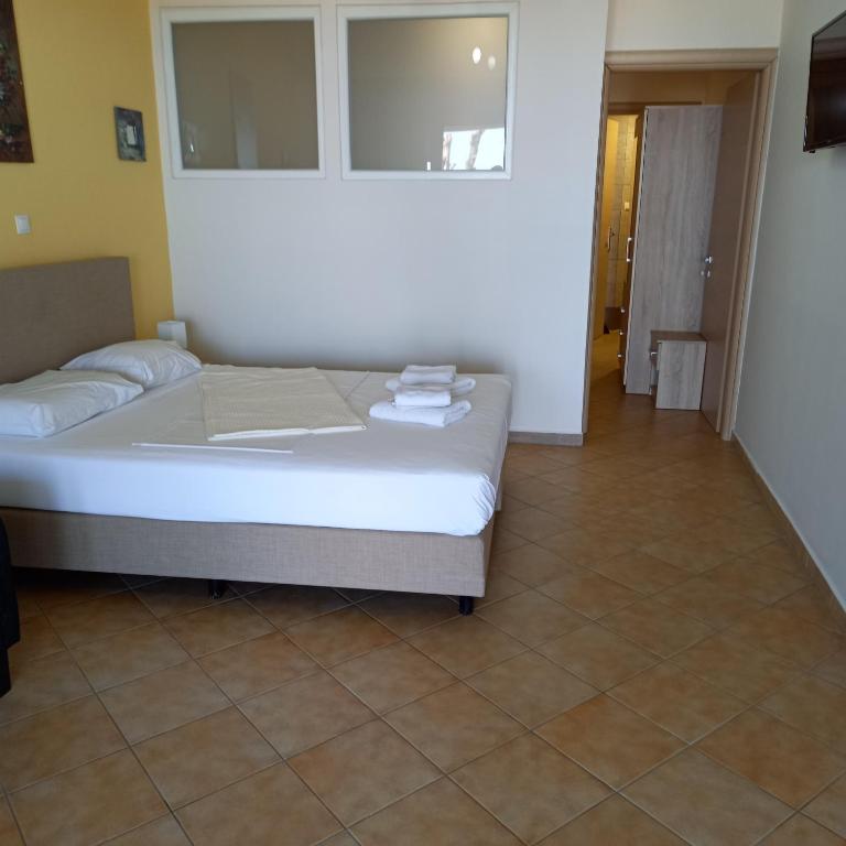 A bed or beds in a room at Rooms Kavala
