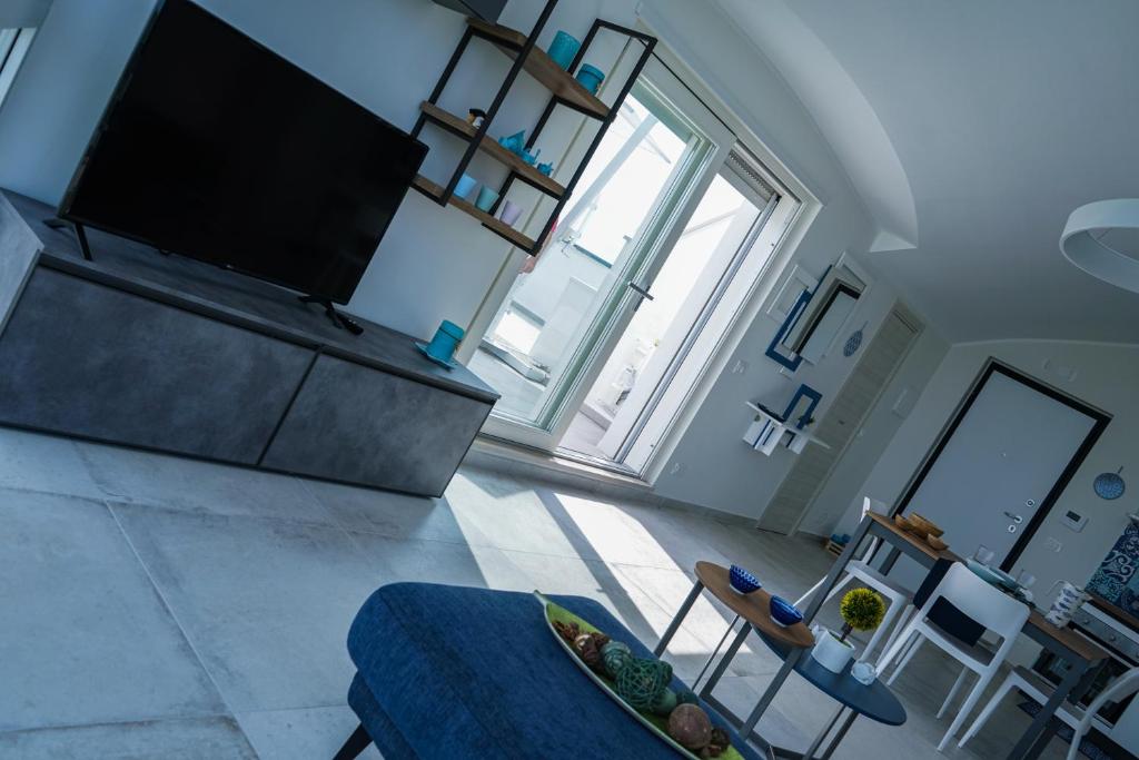 Televízia a/alebo spoločenská miestnosť v ubytovaní NSM Blumarine Attico con terrazza e servizio spiaggia
